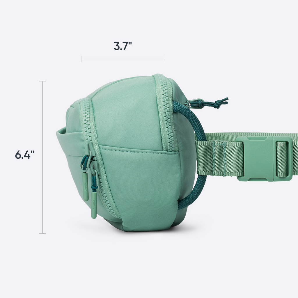 All-Day Crossbody in Sea Glass, light blue ripstop body unzipped to show internal split mesh pocket holding cards and small essentials, with text reading "smart storage with split mesh pocket"