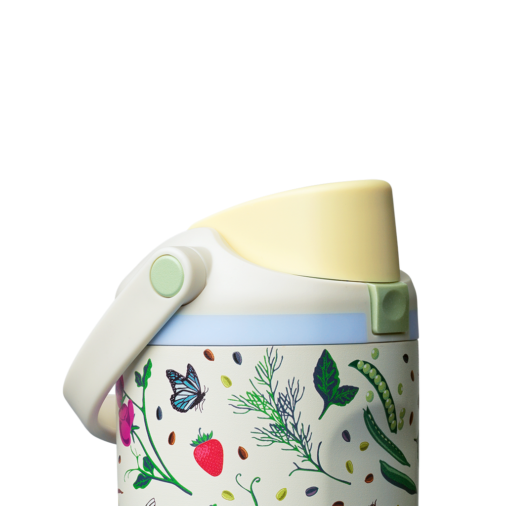 Owala FreeSip Sway 30oz, cream body with garden-themed butterfly, strawberry, leaf, and pea-pod pattern, light blue lid accent ring, butter yellow flip cap, and cream carry loop folded down with sage green swivel detail