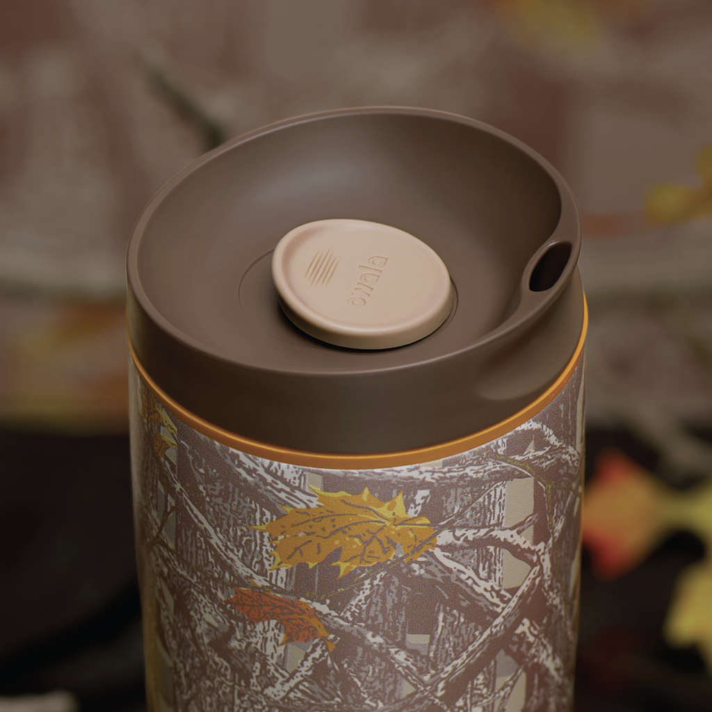 SmoothSip Slider in Out of Sight, lid detail showing brown flip cap with cream push-button and orange accent over woodland camo patterned body