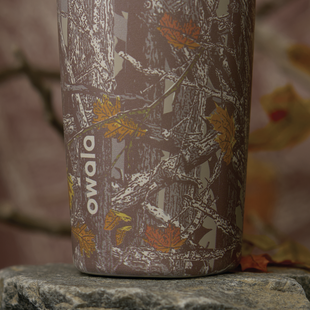 SmoothSip Slider in Out of Sight, close-up of woodland camo patterned body with white logo